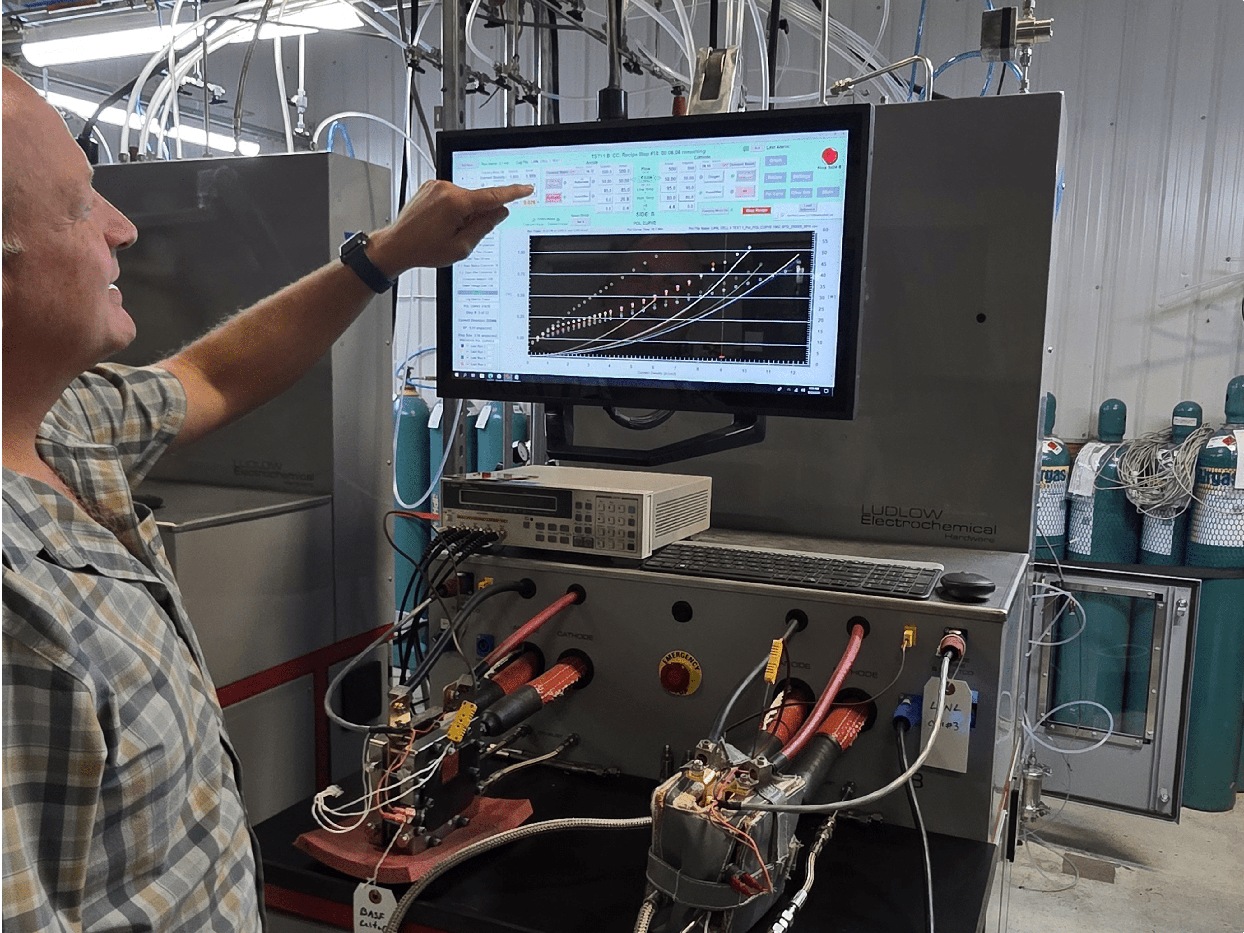 Technician operating a Beetronics touchscreen during fuel cell test